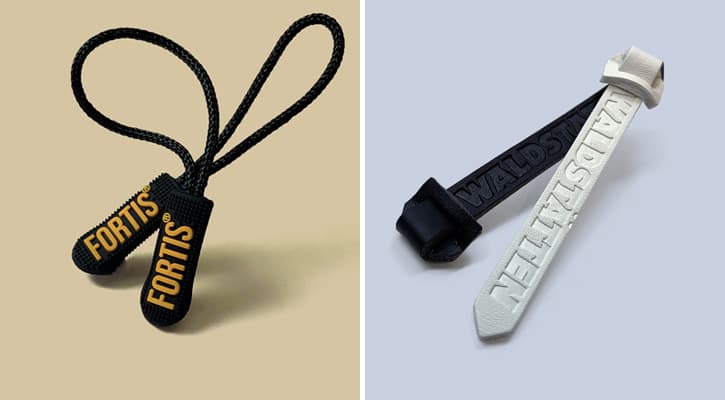 Rubber and leather branded zipper pulls for clothing.