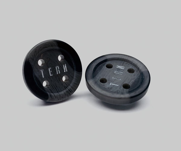 Sew-on buttons for branding outerwear garments.