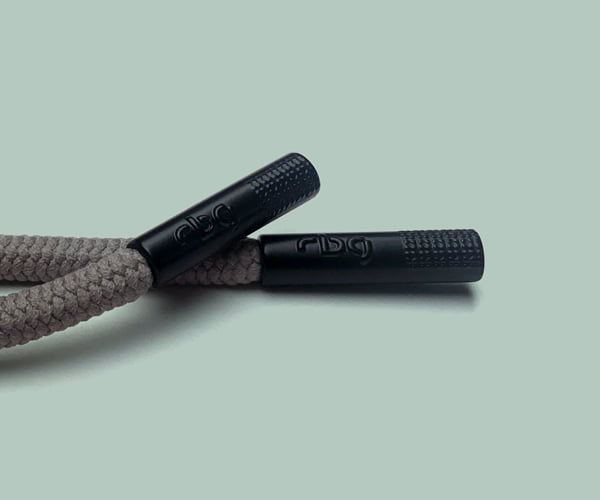Custom cord ends for branding outerwear garments.