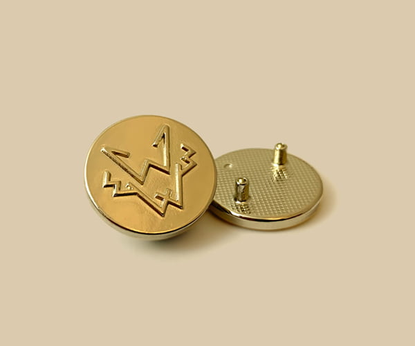 Metal decals and badges for outerwear apparel branding.