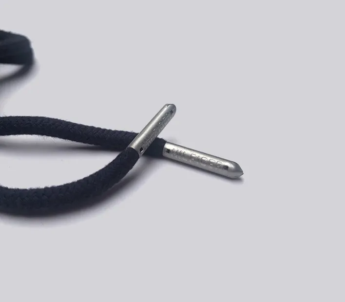 Metal engraved clothing cord end.