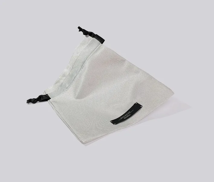 Cotton dust bag with woven label branding.