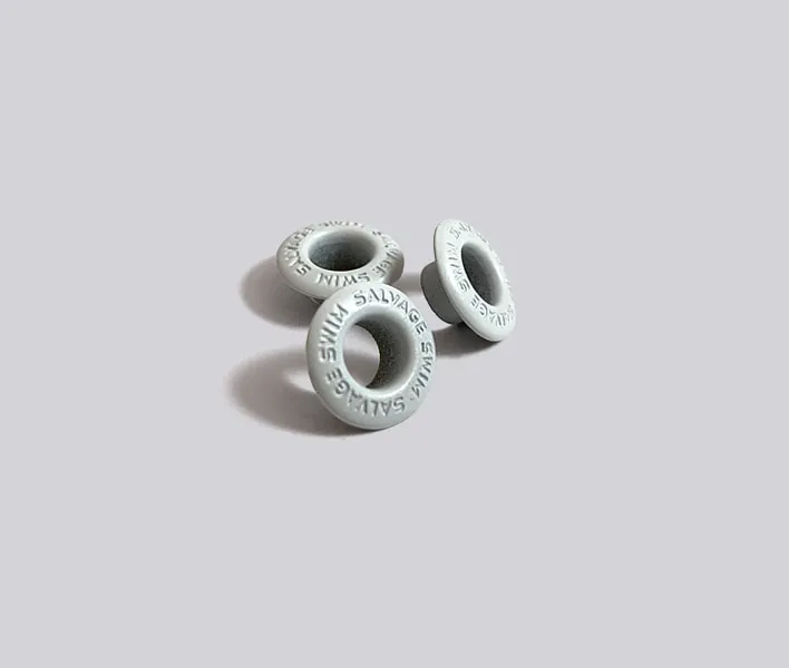 White enamal branded metal clothing grommets.