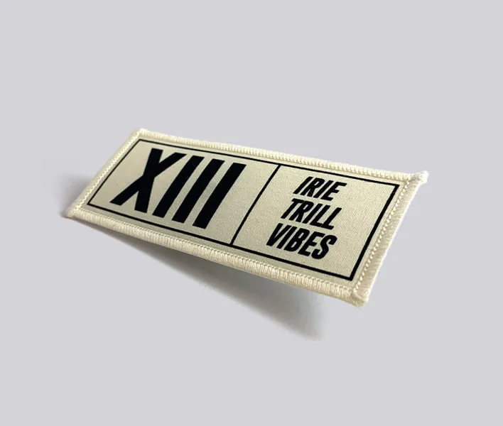 XIII Personalised printed clothing badge.