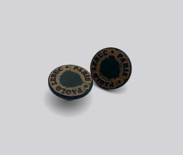 Die-cast alloy jeans button in distressed finish.