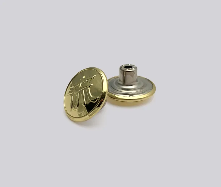 Embossed brass gold finish jeans button.