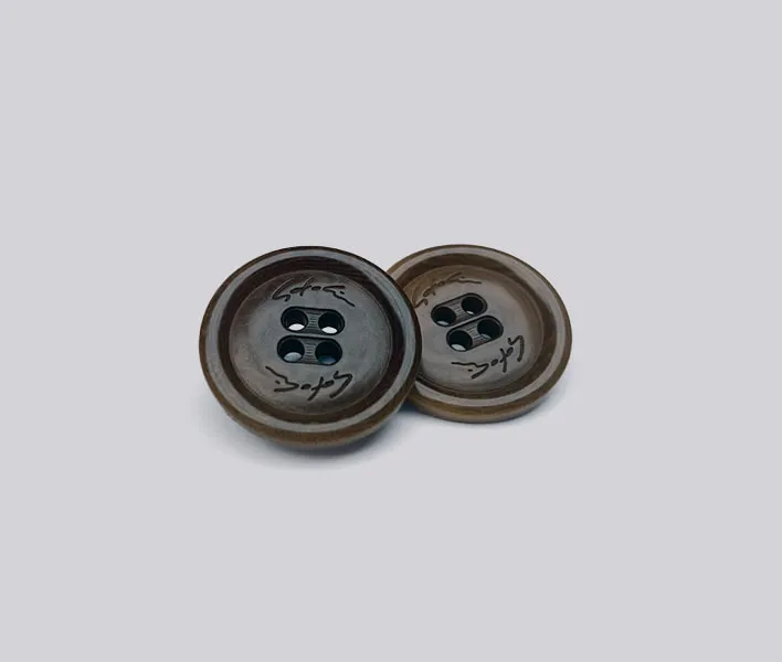 Corozo sew-on button with engraved logo.