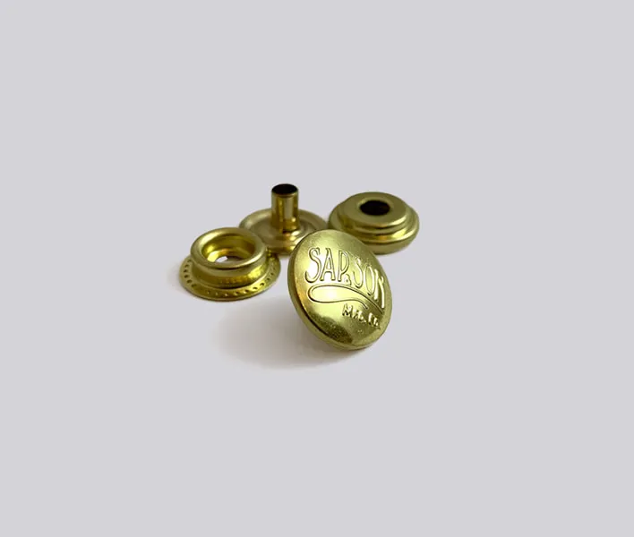 Brass cap branded press fastener set.