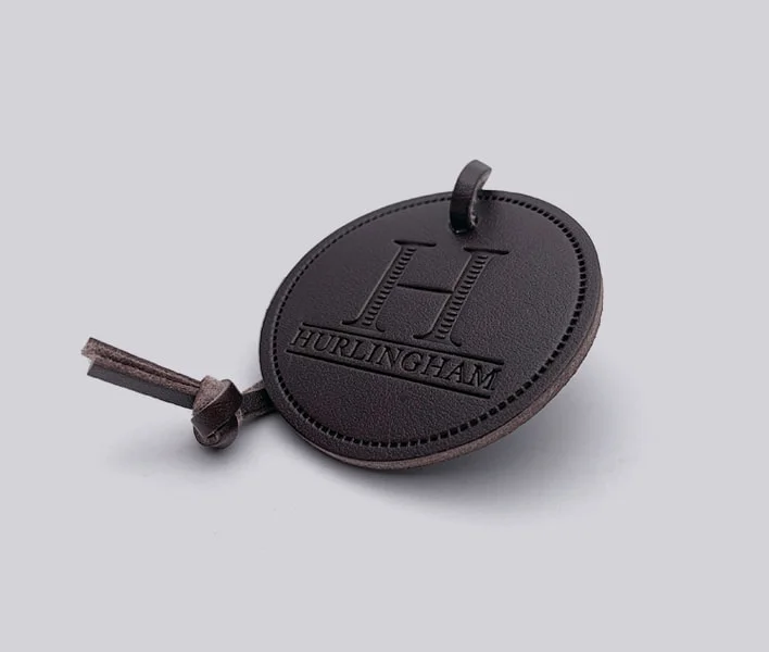 Faux leather hang tag for clothing and apparel.